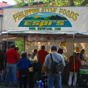 a group of people at a food stand