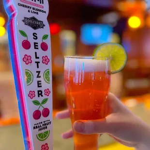 a person holding a glass of beer