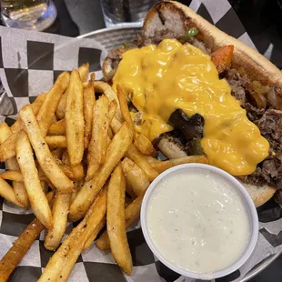 Philly Cheesesteak with house made cheese sauce, onions, peppers and mushrooms.