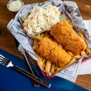a basket of fish and fries with coleslaw and coleslaw