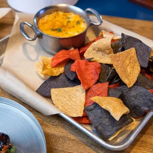 a plate of chips and a bowl of dip