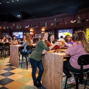 a group of people sitting at a bar