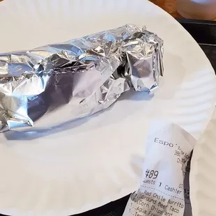 a burrito on a paper plate