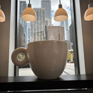 a cup of coffee in front of a window