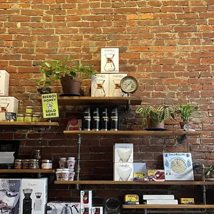 a brick wall and shelves with various items