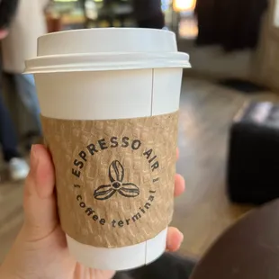 a person holding a coffee cup