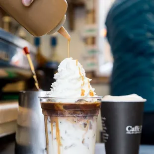 a person pouring coffee into a cup