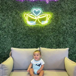 a baby sitting on a couch