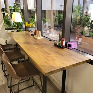 a table and chairs in front of a window
