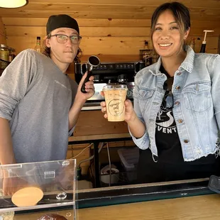 a man and a woman holding a cup of coffee