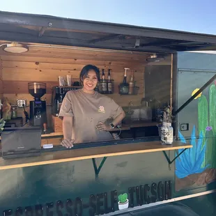 a woman behind a food truck