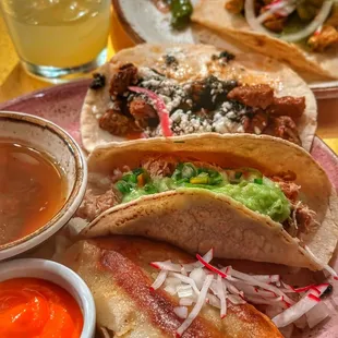 a plate of tacos and a bowl of salsa
