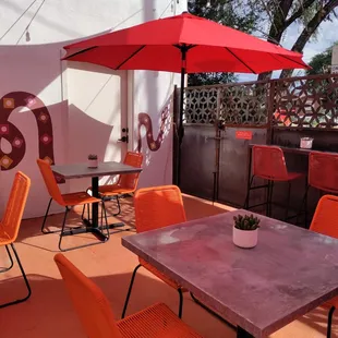 a patio with tables and chairs