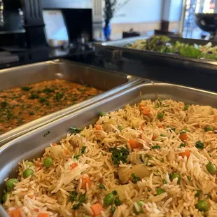 two pans of rice and vegetables
