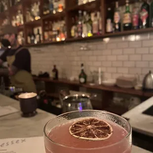 a drink in a glass on a bar counter