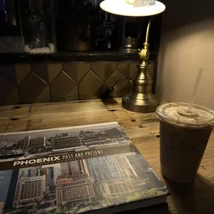 a book and a drink on a table