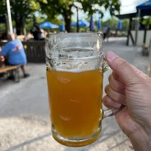 a person holding a glass of beer