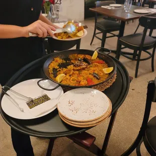 a woman serving a plate of food