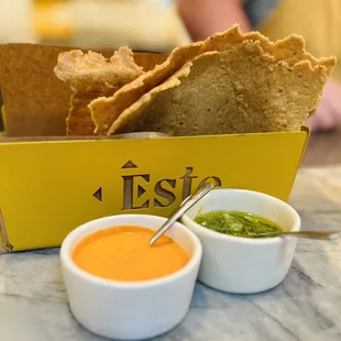 Complimentary chips with Jalapeño Cilantro and Habanero Fresno sauces/dips.