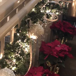 Garland, white lights, gorgeous ornaments with red poinsettias