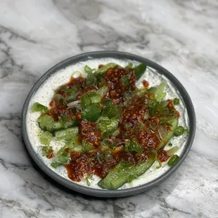 Marinated cucumbers with salsa macha and whipped sheep&apos;s cheese