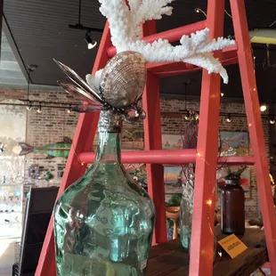 Agnes Strauss vintage bottles transformed into sculpture using shells