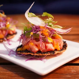 two appetizers on a white plate