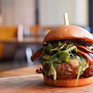 a burger with bacon and lettuce