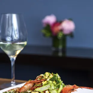 grilled lobster with zucchini and a glass of wine