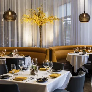 tables and booths with white tablecloths