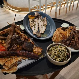 Mix grill platter, lamb chops, grilled fish, and spinach rice