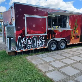 a taco truck parked on the side of the road