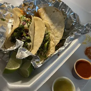 Two Carne Asada tacos and one Al Pastor taco (salsas on the side)