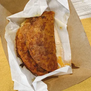 a close up of a sandwich in a paper bag