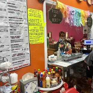a woman standing at a counter in a mexican restaurant