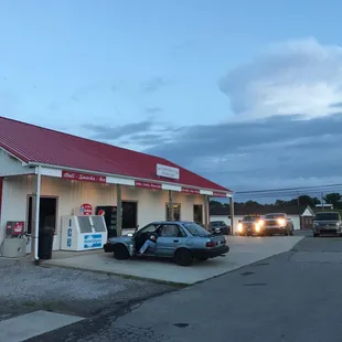 a car parked in front of a gas station