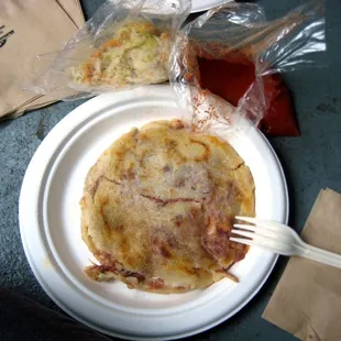 Beef, pinto beans, and cheese pupusa with cole slaw and hot sauce