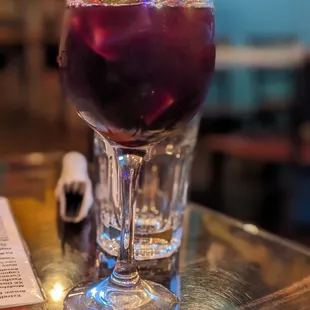 a purple drink in a glass