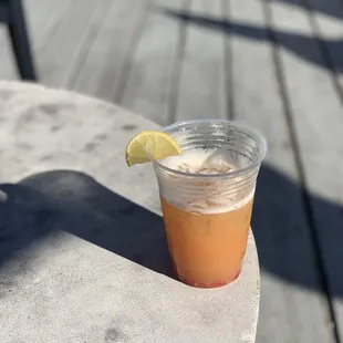 a drink in a plastic cup on a table