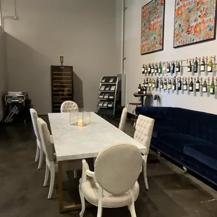 a white marble dining table surrounded by white chairs