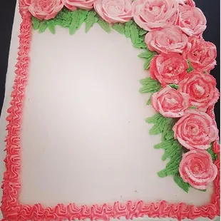 a cake decorated with pink roses