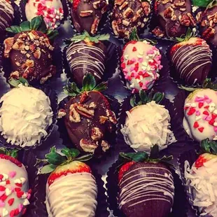 Strawberry covered in chocolate with the option of pecans, coconut flakes, sprinkles and drizzled white chocolate