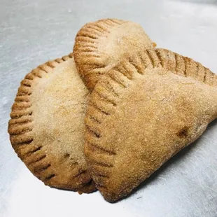 two pastries on a metal surface