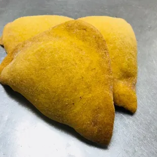 two pastries on a metal surface