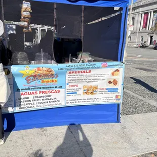 a woman standing in front of a food stand