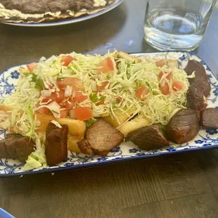 Fried yucca with crispy fried pork bits and pickled cabbage.