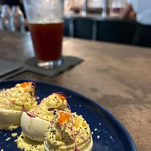 a plate of deviled eggs on a table