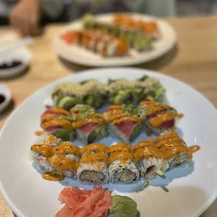 a plate of sushi with salmon and avocado