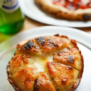 a pizza and a beer on a table