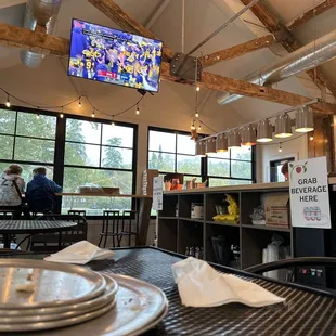 a view of a restaurant with a large screen tv